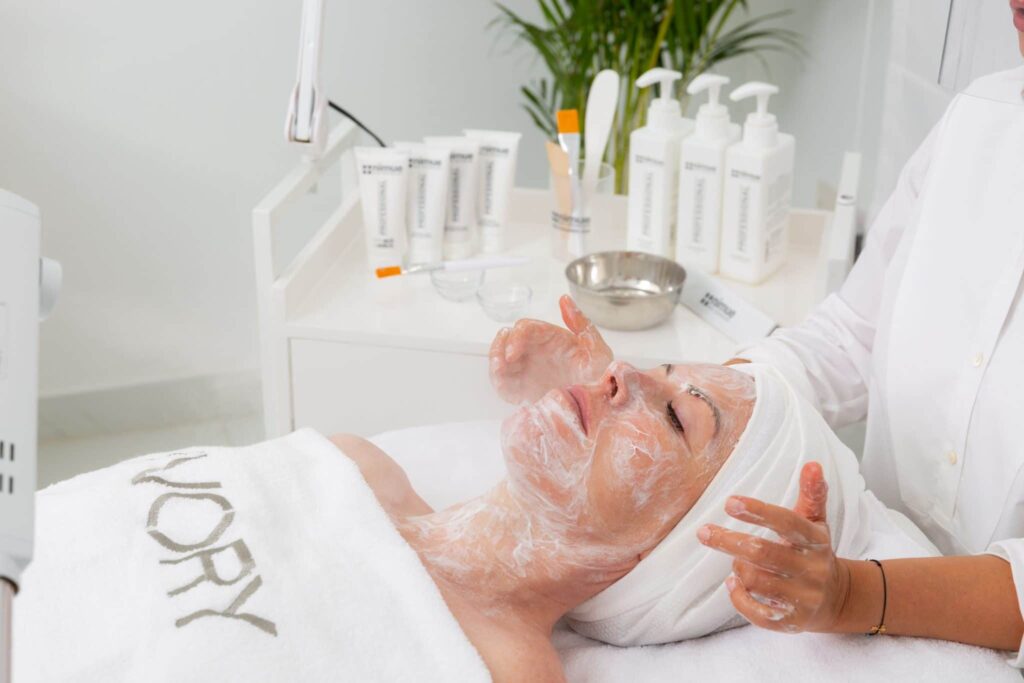 Close-up of hands performing a facial massage technique